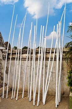 White bamboo pole by an ancient wall of a temple in indonesia 