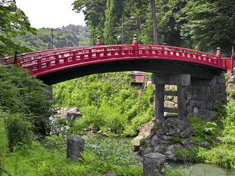 View of a traditional red bridge in a japanese village