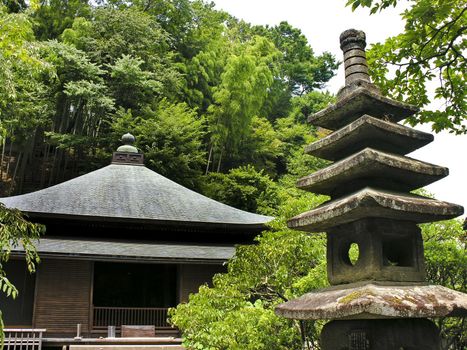 Little japanese religious shrine in a green forest