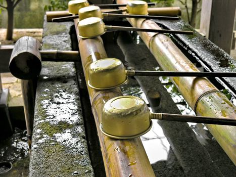 A hand washing and purification fountain outside a Japanese Temple in Kyoto