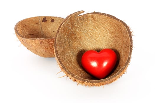 Heart in coconut shell isolated on white