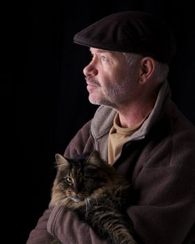 Older gentleman holding his cat