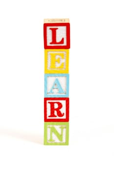 Childrens colorful blocks spell the word learn.