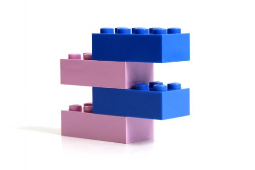 Blue and pink blocks stacked and indicate boy or girl in pregnancy.