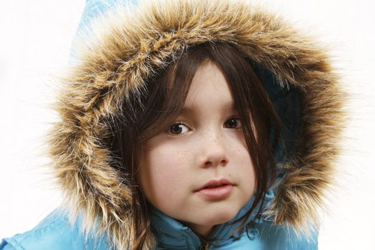 A little girl with a winter coat and hood up like an eskimo.
