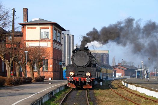 Old retro steam train stopped at the small station
