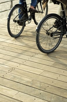 Detail of couple riding bicycle