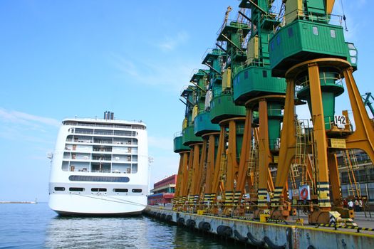 Moored passenger cruise liner and cranes at harbor