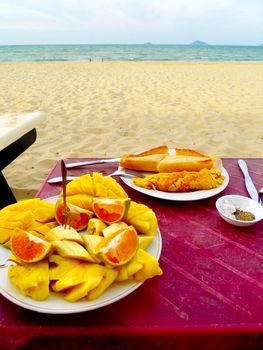 Snack of fruit and sandwich by the sea