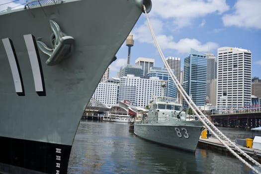 Sydney CBD skyline beypnd warships permamently moored at Darling Harbour, Australia.