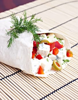 Lavash with a cheese filling, tomato, peppers, olives and fennel.
