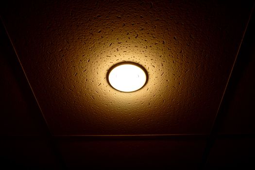 One lamp on the ceiling isolated on black