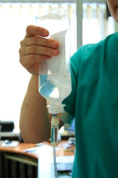 Nurse is holding infusion system in clinic
