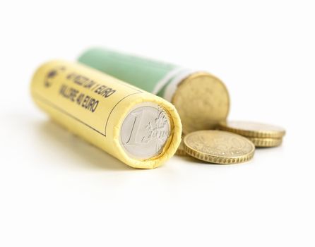 Money concept. Rolls of Euro coins on white