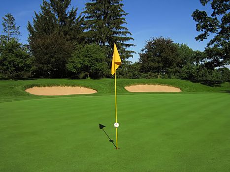 A photograph of a golf course in the afternoon.