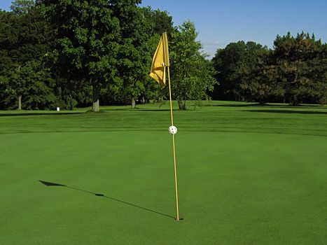 A photograph of a golf course in the afternoon.