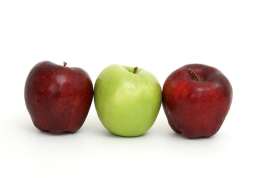 Three apples with the center one being green.