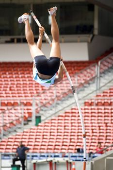 Image of a female pole vaulter in action.