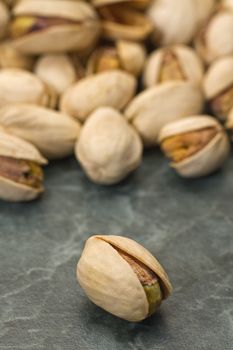 multiple salted pistachios, warm brown color, distance blur