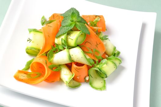 Zucchini salad with carrots and garlic marinade with herbs