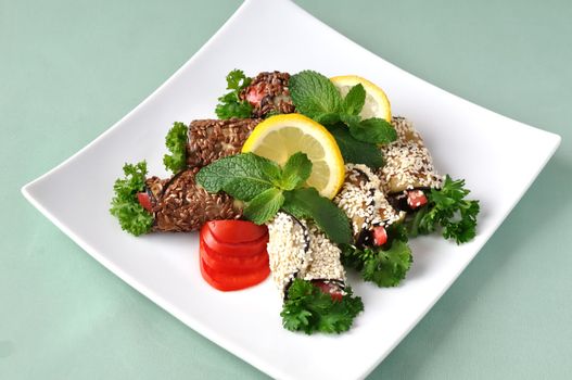 Rolled eggplant with tomatoes in sesame and flax seed