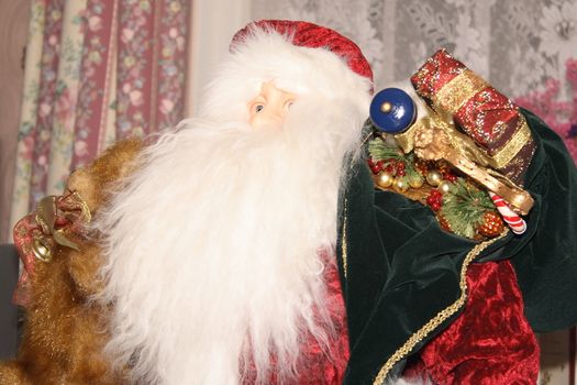 large santa claus decoration with his sack of presents and long white beard