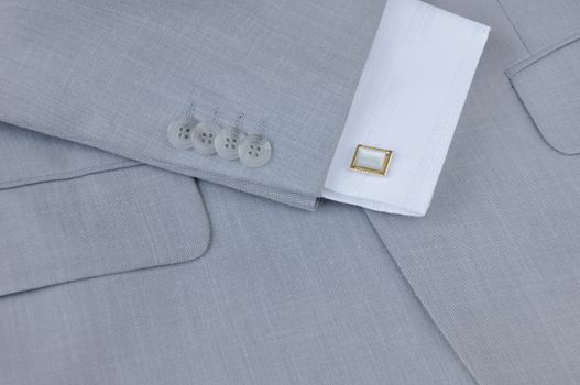 Fragment of men's suit with cuffs and cuff links, close-up