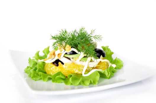 Appetizer of avocado, orange, black grape cream sauce sprinkled with peanuts