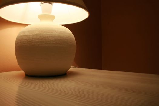 table lamp on a wooden cabinet in a hotel room interior