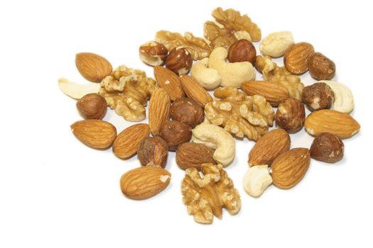 pile of mixed shelled nuts full of protein goodness for good health isolated over a white background