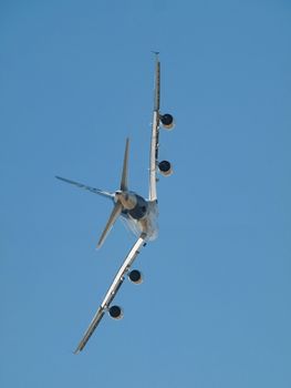 Rear profile of an aircraft  flying in blue sky