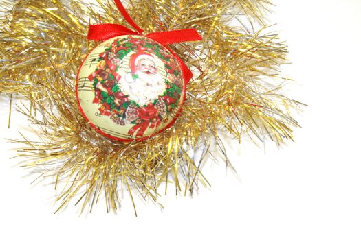 gold  tinsel with ornate papiermache bauble and bow christmas decorations for hanging on the christmas tree isolated over white background