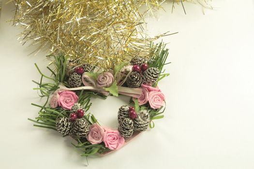 gold and silver tinsel with heart shaped wreath christmas tree decorations over a light background