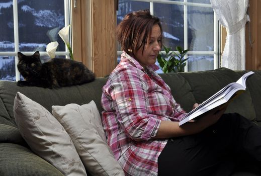 a woman is reading a book