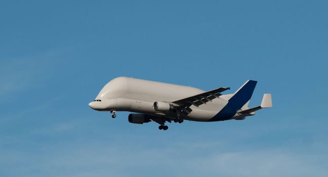 Cargo carrier flying in blue sky
