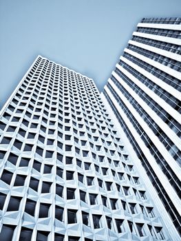 Skyward view of two skyscrapers under blue sky hdr processed and selenium filter applied