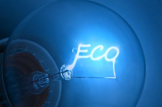 Close up on illuminated blue light bulb filament spelling the word "Eco".