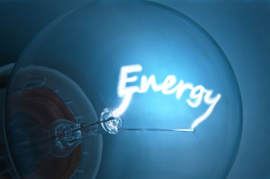 Close up on illuminated blue light bulb filament which spells the word "Energy".