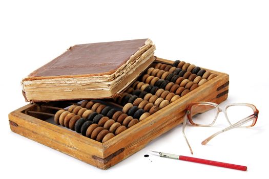Image of an old book lying on the accounts, close to the points and pen isolated on white background
