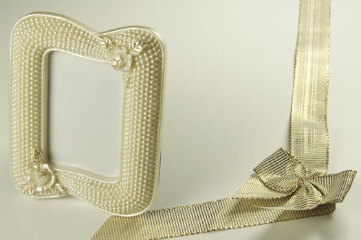 golden ribbon and bow with a pearl picture frame