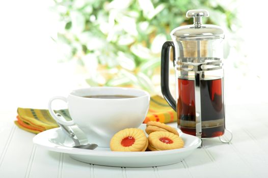 Delicious cream filled vanilla cookies with a cup of coffee.