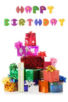 Stack of colorful gift boxes with real reflection and plasticine words 'Happy birthday'. isolated over white background