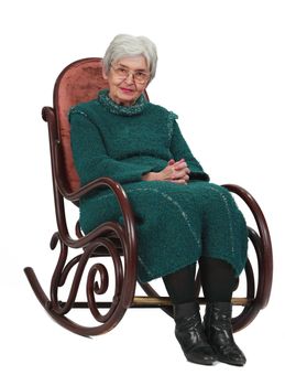 Old woman sitting on a wooden rocking chair isolated against a white background.