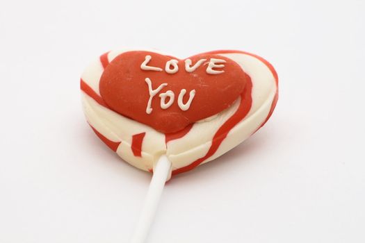 candy lolly with love you written on a red heart
