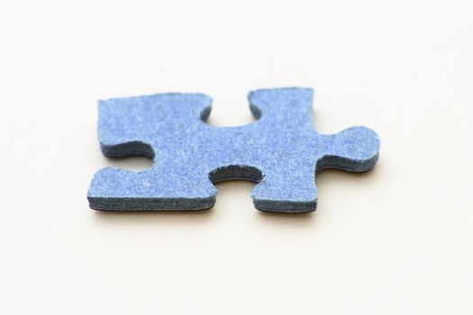 blue piece of jigsaw puzzle over   white background