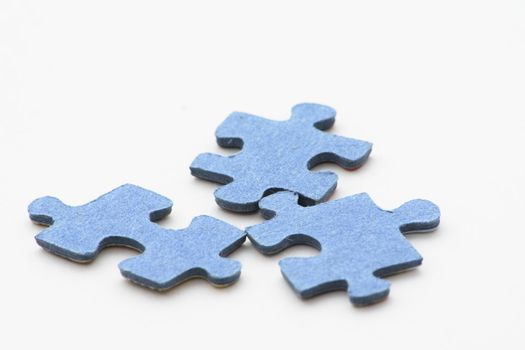blue pieces of jigsaw puzzle over   light background