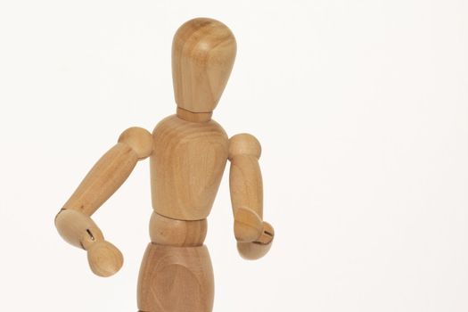wooden mannequin against a light background