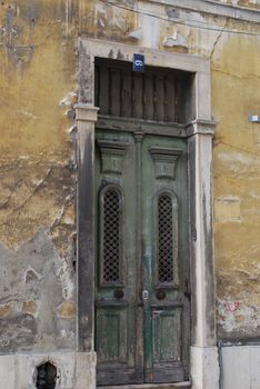 facade and door of a old building going down