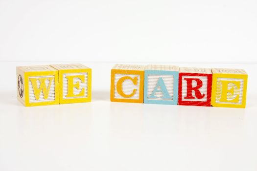 Colorful childrens blocks spell the words we care.