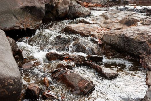 fresh clean water going over the rocks in a little stream